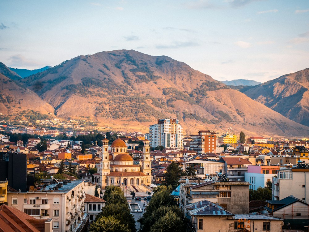City in Albania with mountains behind it