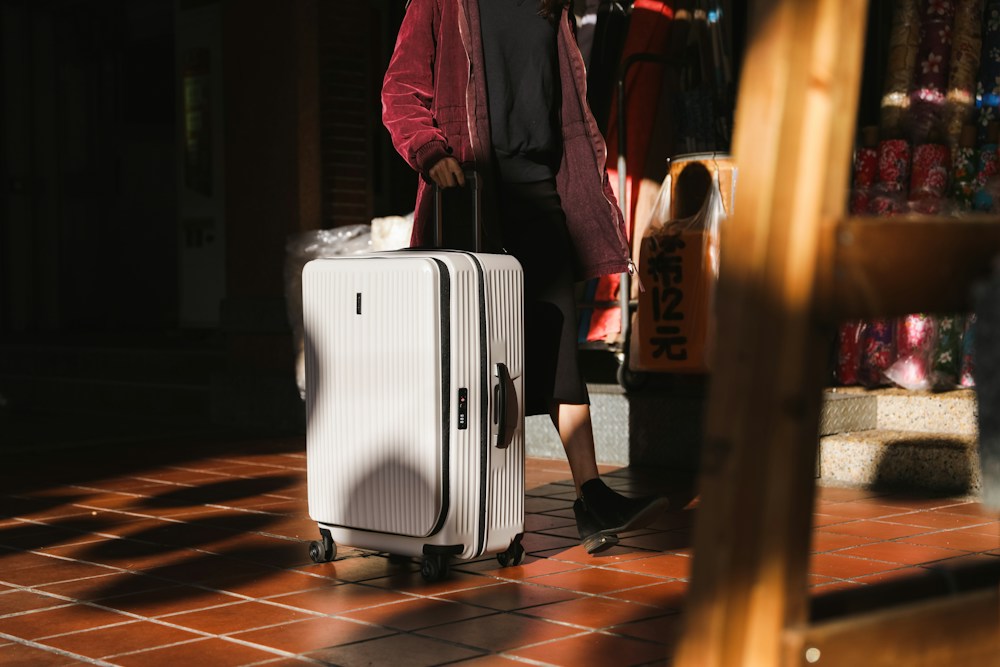 Traveller with a white suitcase